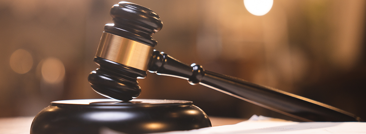 A judge's gavel resting in a courtoom.