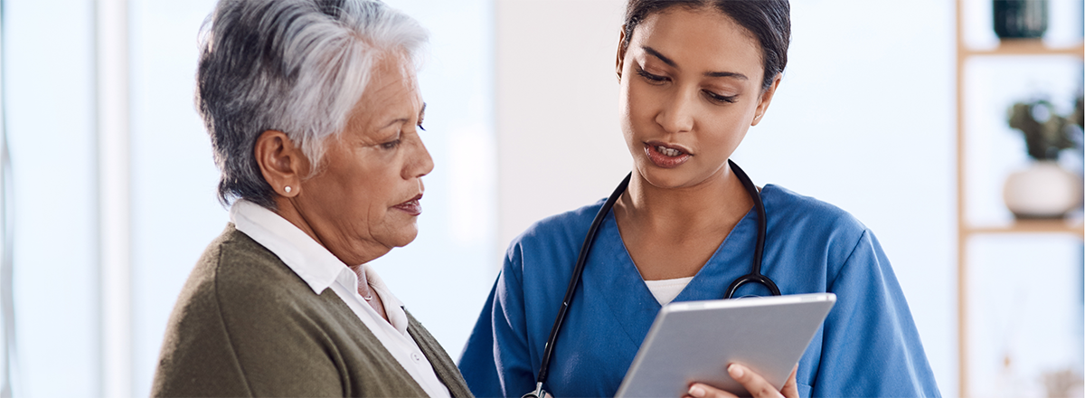 Nurse explaining chart to female patient.