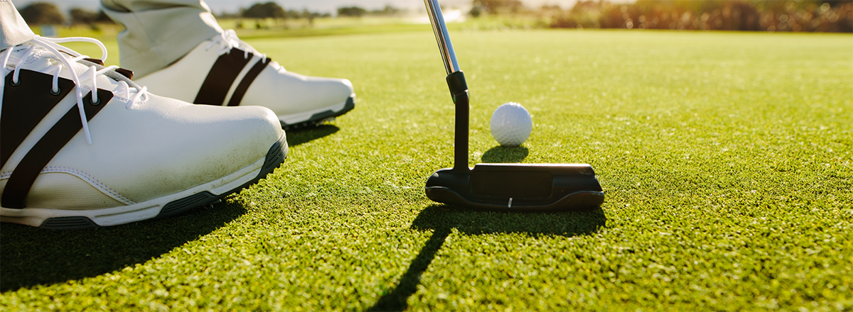 Man putting on a golf green.